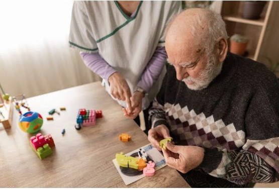 Person living with dementia engaged in activity with caregiver